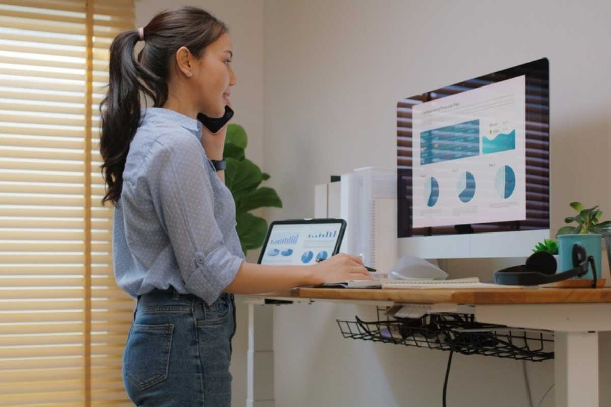 ragazza in piedi di fronte scrivania tech elettrica regolabile